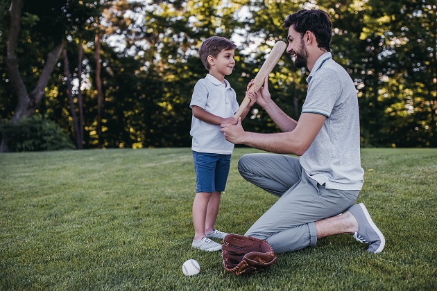 Dad with son playing baseball